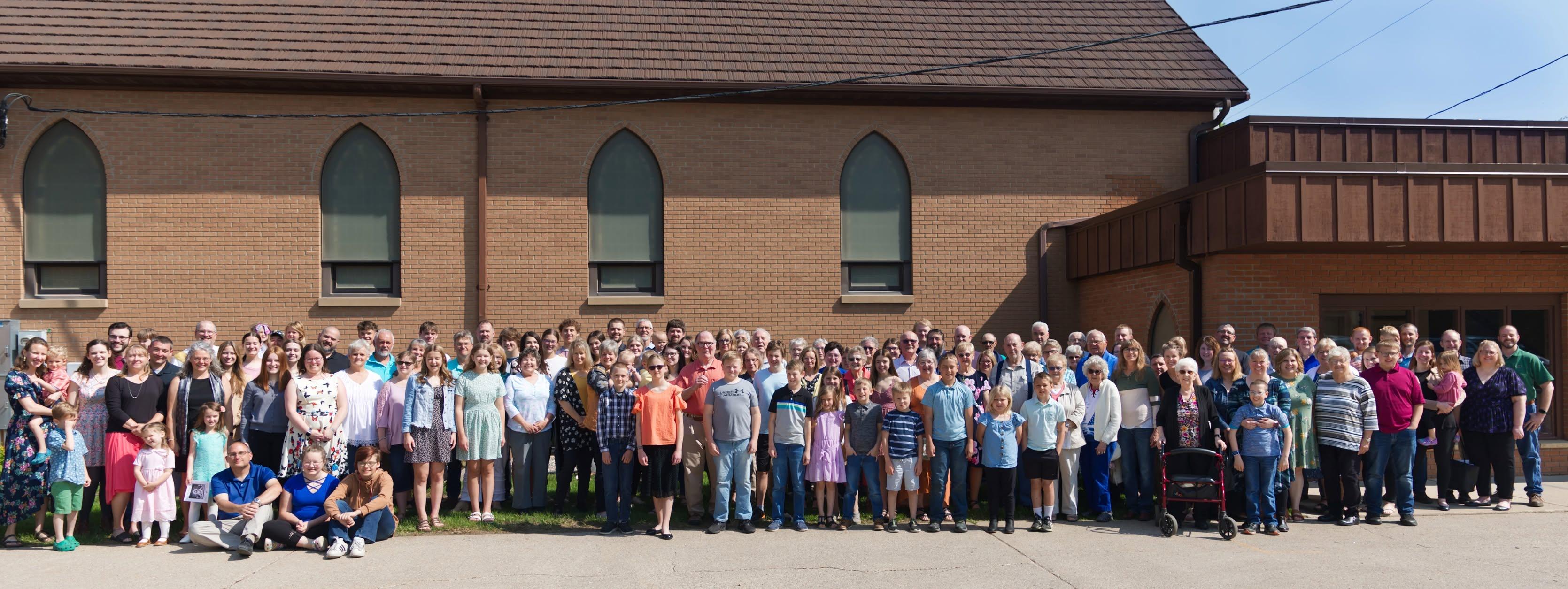 Members of Trinity Evangelical Lutheran Church gathered outside the front of the church